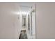 Hallway with tile flooring, neutral wall color, and doors leading to various rooms at 6841 46Th N St, Pinellas Park, FL 33781