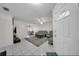 Bright living room, tile floors, open floor plan with a ceiling fan, and a white front door at 6841 46Th N St, Pinellas Park, FL 33781