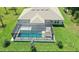 Aerial view of the backyard featuring a screened-in pool and well-maintained landscaping at 7664 Meroni Blvd, North Port, FL 34291