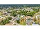 Wide aerial shot of single Gathering homes in a residential neighborhood, with lush green trees at 78 Zenith St, Port Charlotte, FL 33954