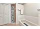 Clean bathroom with soaking tub and separate tiled shower under bright lighting at 78 Zenith St, Port Charlotte, FL 33954