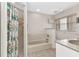 Bright bathroom with tiled shower and separate soaking tub under a window at 78 Zenith St, Port Charlotte, FL 33954