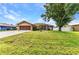 Charming home with a well-maintained lawn, mature tree, and inviting curb appeal at 78 Zenith St, Port Charlotte, FL 33954