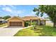 Inviting single-story home showcasing manicured landscaping and a spacious driveway at 78 Zenith St, Port Charlotte, FL 33954