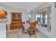 Cozy dining area with wooden furniture, a hutch, and bright windows for ample natural light at 78 Zenith St, Port Charlotte, FL 33954