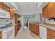 Open kitchen with wood cabinets and breakfast area showcasing the seamless entertaining possibilities at 78 Zenith St, Port Charlotte, FL 33954