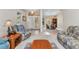 Spacious living room seamlessly flowing into the dining area, with decorative glass doors at the entryway enhancing the ambience at 78 Zenith St, Port Charlotte, FL 33954