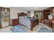 This bedroom boasts a gorgeous carved wood bed frame and matching furniture set, bathed in natural light from two windows at 78 Zenith St, Port Charlotte, FL 33954