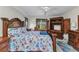 This bright, spacious main bedroom features a large carved-wood bed frame, desk, and entertainment center at 78 Zenith St, Port Charlotte, FL 33954
