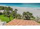 Beachfront property with lush palm trees and a sandy shoreline at 876 Golden Beach Blvd # 876, Venice, FL 34285