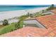 Coastal view showcasing a beach with palm trees from a rooftop perspective at 876 Golden Beach Blvd # 876, Venice, FL 34285