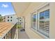 Balcony view showcasing a tranquil neighborhood and the building's architectural details including tiled roof at 876 Golden Beach Blvd # 876, Venice, FL 34285
