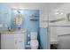 Bright bathroom with a granite countertop vanity, shell mirror, and tiled shower at 876 Golden Beach Blvd # 876, Venice, FL 34285