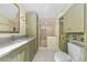 Bright bathroom features beautiful stone countertops, wood cabinets, and a glass-enclosed shower at 876 Golden Beach Blvd # 876, Venice, FL 34285