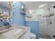 Updated bathroom with a granite countertop vanity, seashell decor, and glass-enclosed shower at 876 Golden Beach Blvd # 876, Venice, FL 34285