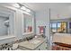 Beautiful bathroom features double mirrors, mosaic tile accents, and a view of the ocean at 876 Golden Beach Blvd # 876, Venice, FL 34285
