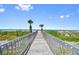 Picturesque boardwalk leading to a pristine beach with palm trees at 876 Golden Beach Blvd # 876, Venice, FL 34285