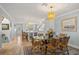 Open-concept dining area and kitchen featuring a glass table, comfortable seating and hardwood floors at 876 Golden Beach Blvd # 876, Venice, FL 34285