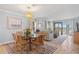 Elegant dining area with stylish chandelier, glass top table and seamless transition to the living space at 876 Golden Beach Blvd # 876, Venice, FL 34285