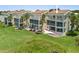 Exterior of condo with large screened lanais and lush tropical landscaping at 876 Golden Beach Blvd # 876, Venice, FL 34285