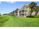 Exterior of condo with large screened lanais and lush tropical landscaping at 876 Golden Beach Blvd # 876, Venice, FL 34285