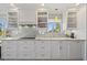 Well-lit kitchen with shaker cabinets, granite countertops, and stainless steel appliances at 876 Golden Beach Blvd # 876, Venice, FL 34285