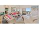 Comfortable living room with ocean view and sliding glass door to the balcony at 876 Golden Beach Blvd # 876, Venice, FL 34285