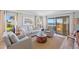 Bright living room features comfortable seating and a large sliding glass door with ocean views at 876 Golden Beach Blvd # 876, Venice, FL 34285