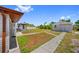 Backyard with a gazebo, a workshop and a large yard with mature trees at 10517 Greenway Ave, Englewood, FL 34224
