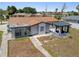 The backyard has a covered gazebo, gravel landscaping and mature shade trees at 10517 Greenway Ave, Englewood, FL 34224