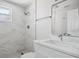 Modern bathroom features marble-tiled shower, stylish vanity, and sleek fixtures at 10517 Greenway Ave, Englewood, FL 34224