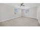 Bright bedroom with two windows, ceiling fan, and neutral walls provides a calming retreat at 10517 Greenway Ave, Englewood, FL 34224