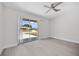 Bedroom with sliding glass door and fan, offering abundant natural light and a relaxing ambiance at 10517 Greenway Ave, Englewood, FL 34224