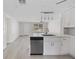 Bright kitchen boasts stainless steel appliances, pendant lighting, and an open layout with an eat-in island at 10517 Greenway Ave, Englewood, FL 34224