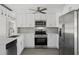 Well-lit kitchen with stainless steel appliances, granite countertops, and ample storage at 10517 Greenway Ave, Englewood, FL 34224