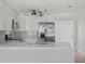 Modern kitchen with white cabinets, stainless steel appliances, and stylish backsplash at 10517 Greenway Ave, Englewood, FL 34224