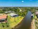 Waterfront property with a screened pool, verdant lawn, and convenient access to the serene canal at 13284 Amaryllis Cir, Port Charlotte, FL 33981