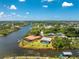 Stunning waterfront home boasting a screened pool, lush grounds, and convenient access to the canal at 13284 Amaryllis Cir, Port Charlotte, FL 33981