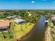 Beautiful waterfront property with screened pool, lush greenery, and access to a tranquil canal at 13284 Amaryllis Cir, Port Charlotte, FL 33981