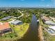 Picturesque waterfront home with screened lanai pool, verdant landscaping, and canal access at 13284 Amaryllis Cir, Port Charlotte, FL 33981