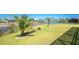Expansive backyard featuring lush green grass, landscaping, and waterfront views at 13284 Amaryllis Cir, Port Charlotte, FL 33981