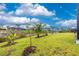 Large green backyard with new growth palm trees leads to a canal waterway at 13284 Amaryllis Cir, Port Charlotte, FL 33981