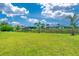 A lush green lawn leads to a tranquil canal waterway in the backyard at 13284 Amaryllis Cir, Port Charlotte, FL 33981