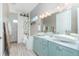 Light and bright bathroom features double sinks, and a tub with a shower at 13284 Amaryllis Cir, Port Charlotte, FL 33981