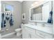 The bathroom has gray walls, wood floors, and a marble vanity with white cabinetry and silver fixtures at 13284 Amaryllis Cir, Port Charlotte, FL 33981