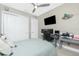 This bedroom includes a ceiling fan, large closet, a desk and a modern gray and wood color scheme at 13284 Amaryllis Cir, Port Charlotte, FL 33981