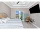 Bright bedroom features a ceiling fan, a TV and direct access to a screened lanai at 13284 Amaryllis Cir, Port Charlotte, FL 33981
