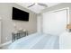 This bedroom includes a ceiling fan, large closet, and an entertainment center with a mounted television at 13284 Amaryllis Cir, Port Charlotte, FL 33981