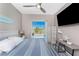 This bedroom features a sliding glass door, side tables with lamps, and coastal-themed décor at 13284 Amaryllis Cir, Port Charlotte, FL 33981