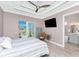 Bright bedroom features a ceiling fan, a TV and direct access to a screened lanai at 13284 Amaryllis Cir, Port Charlotte, FL 33981